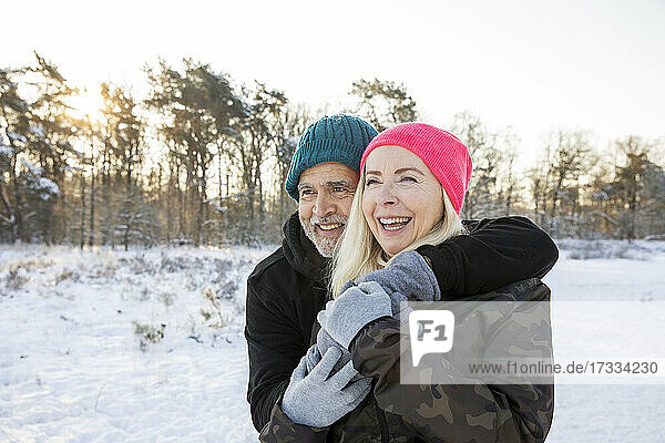 Cheerful senior couple standing together during winter