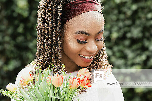 Beautiful smiling young woman with flowers