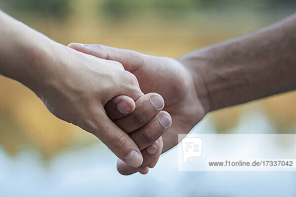 Young multi-ethnic couple holding hands