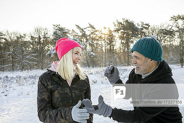Playful senior man and woman enjoying winter together