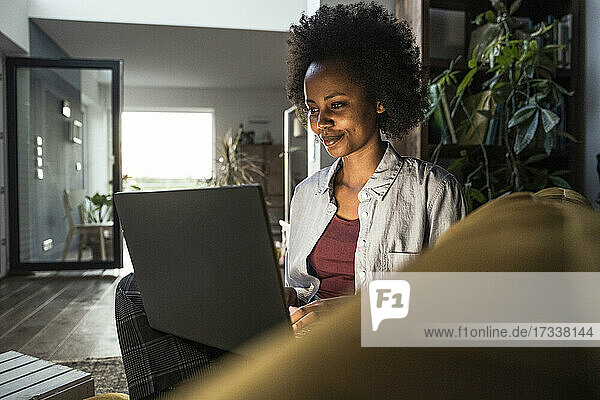 Junge Freiberuflerin mit Laptop bei der Arbeit zu Hause