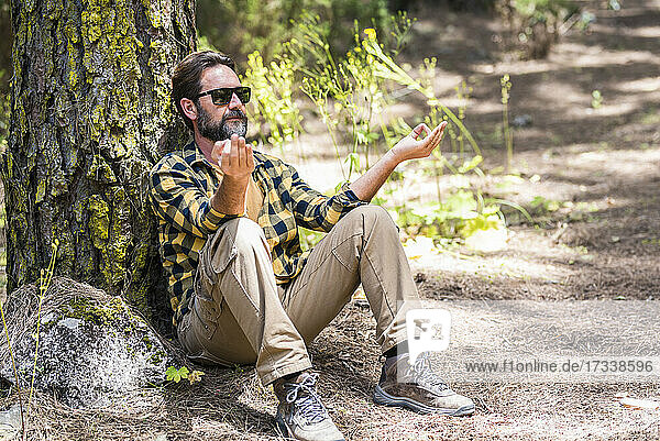 Man doing relaxation exercise in forest