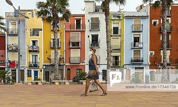 Frau geht vorbei Bunte Häuser am Strand  Cases de Colors  Carrer Arsenal  Villajoyosa  Spanien  Europa