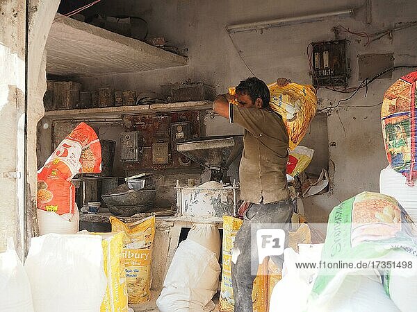Vendor grinding fresh flour at market stall  Sardar Market  Old Town  Jodhpur  Rajasthan  India  Asia
