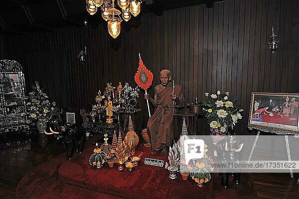 Darkened worship room with monk statue in Buddhist monastery Wat Chalong  Phuket Island  Thailand  Asia