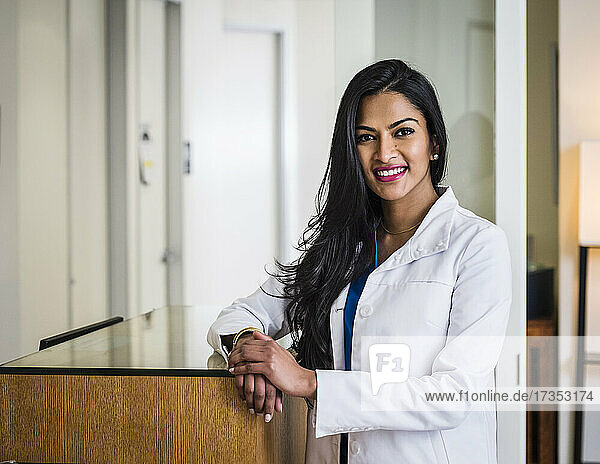 Portrait of female doctor at reception desk