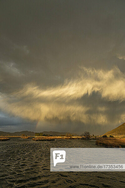 Usa  Idaho  Picabo  Storm clouds over landscape at sunset