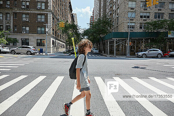 USA  New York  New York City  Boy crossing street