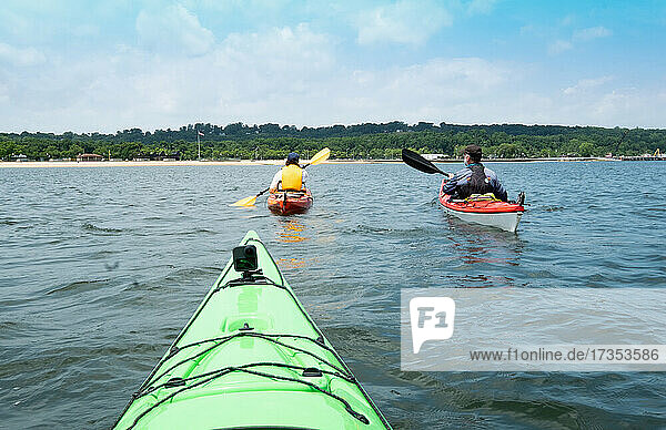 Usa  New York  Port Washington  People kayaking together on sea