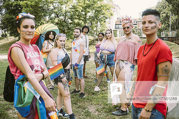 Multi-ethnic male and female friends during pride event in park