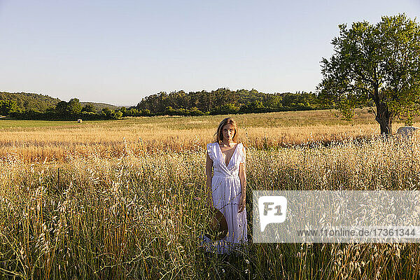 Junge Frau mit Hut in einem Feld