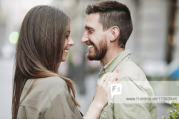 Man smiling while looking at girlfriend