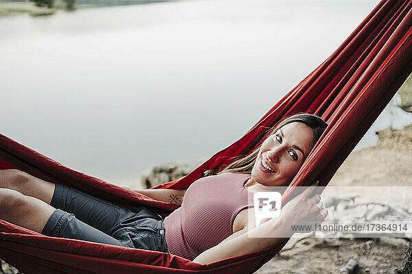 Beautiful woman smiling while relaxing on hammock