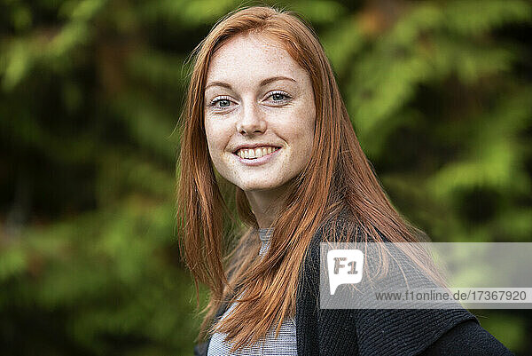 Portrait of smiling young woman in park