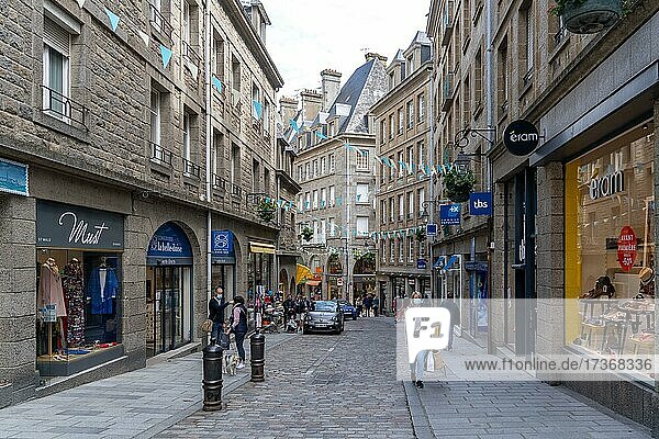 People shopping with masks in the empty streets of the old town of Saint Malo  Brittany  France  Europe