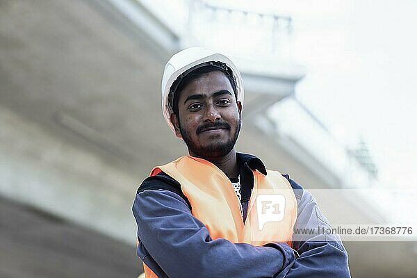 Young technician with beard outside with helmet working on a bridge  Baden-Württemberg  Germany  Europe