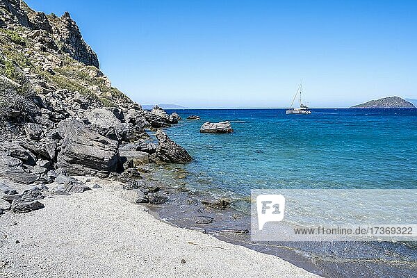 Beach at Gyali  sailing boat behind  Dodecanese  Greece  Europe