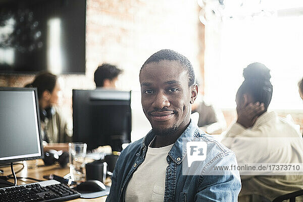 Smiling male entrepreneur at creative office