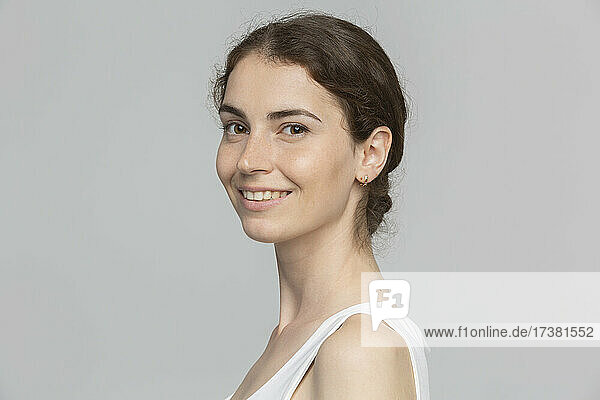 Portrait smiling young woman against white background