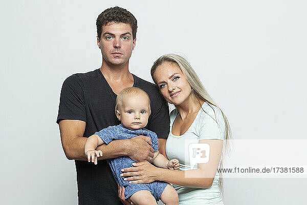 Portrait parents and baby son on white background