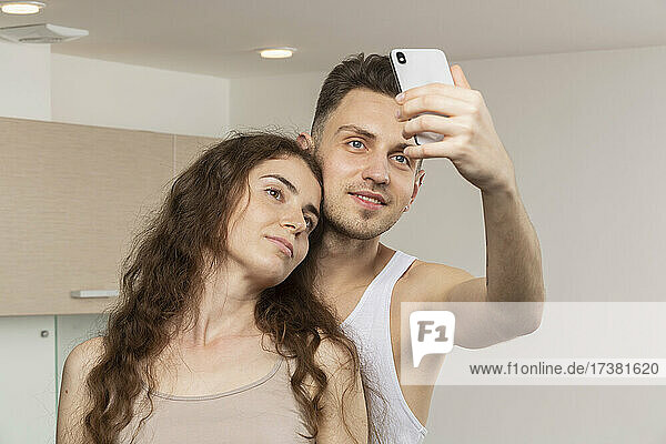 Young couple taking selfie with camera phone
