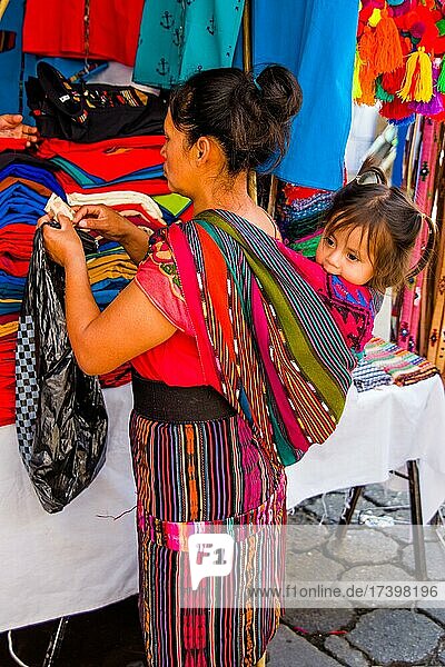 Mother with child on her back  most important market in the highlands  Chichicastenango  Chichicastenango  Guatemala  Central America