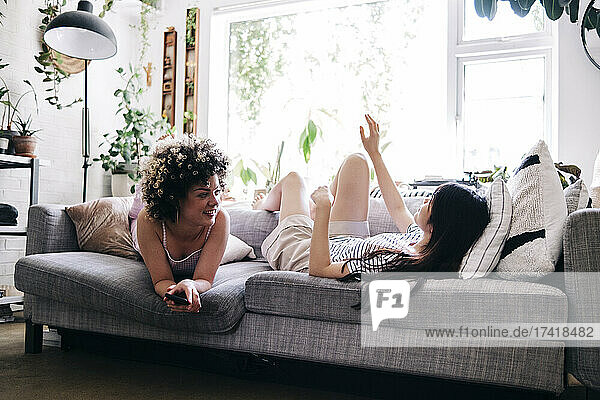 Young women talking while relaxing at home