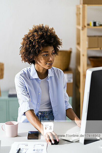 Businesswoman using desktop while working at studio