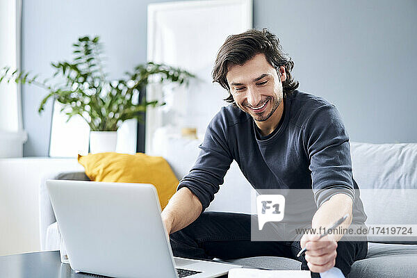 Smiling male professional working at home office