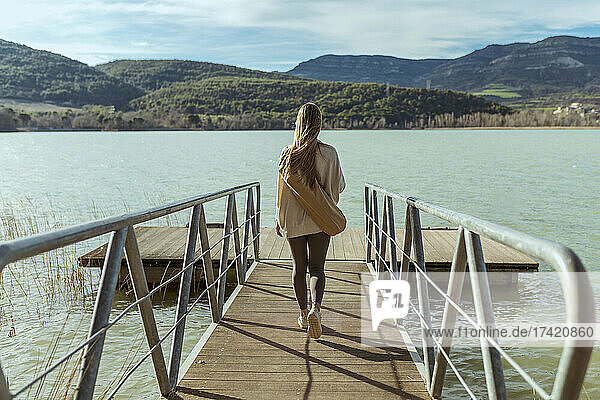Young woman walking on jetty
