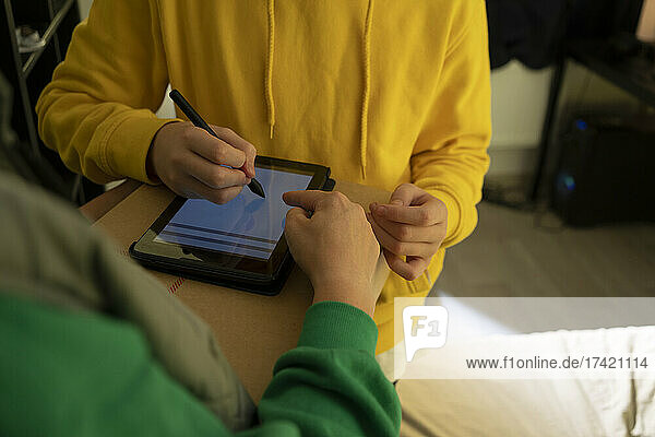 Boy signing reception of package with digitized pen