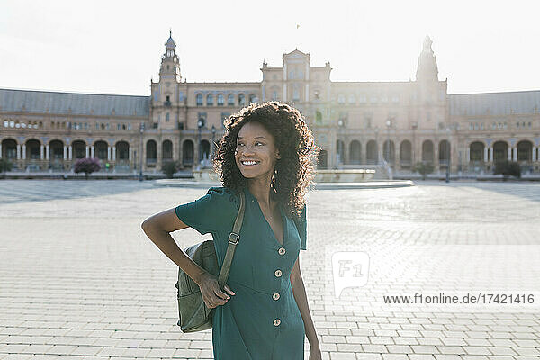 Happy female tourist looking away at Plaza De Espana  Seville  Spain