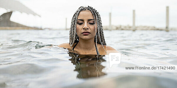 Woman with braided hair in water during weekend
