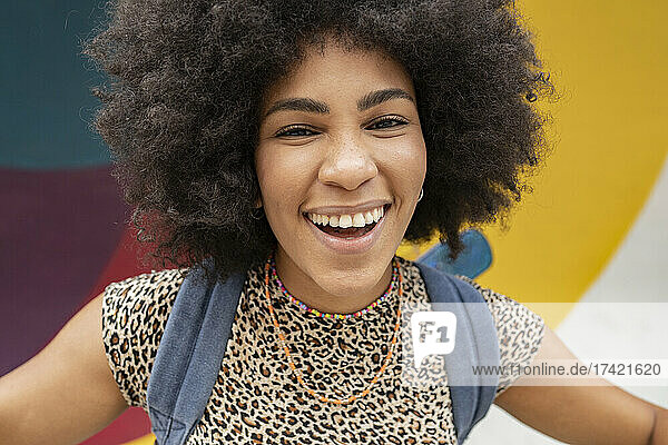 Cheerful young woman with black Afro hairstyle