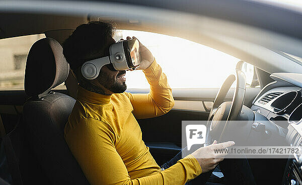 Man using virtual reality headset while sitting in car