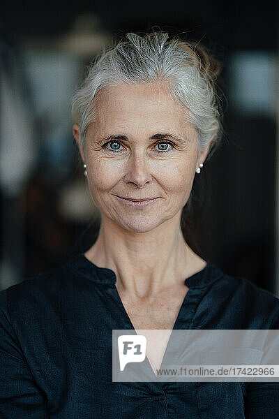 Mature woman with gray hair at cafe