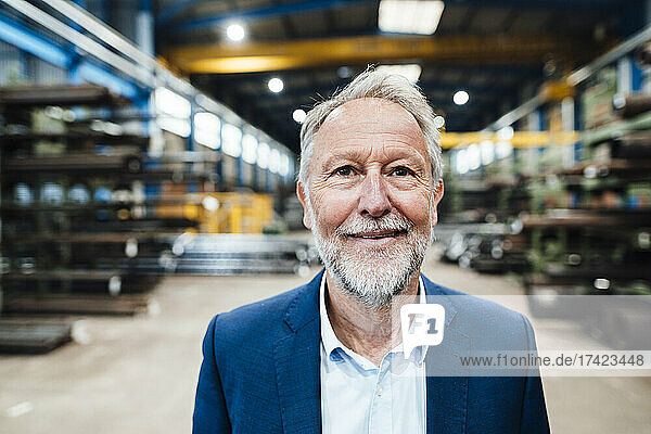 Smiling senior businessman at metal industry