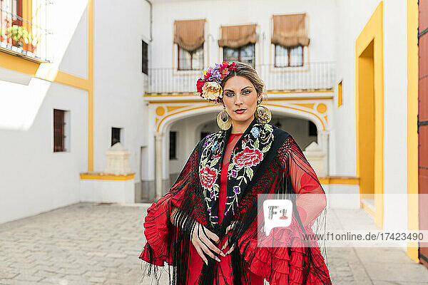 Woman in traditional dress standing at Plaza de toros de la Real Maestranza de Caballeria de Sevilla  Spain