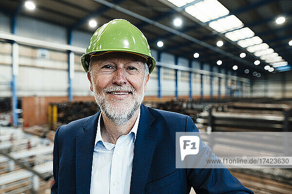 Male managing director with hardhat at metal industry