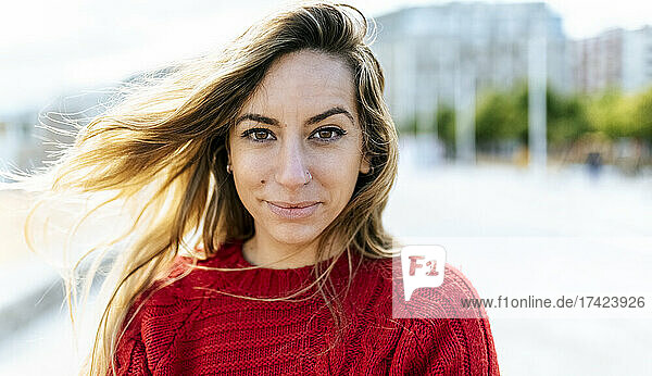 Blond young woman in red sweater