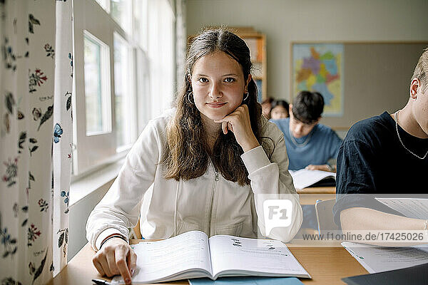 Portrait of teenage girl student in high school classroom