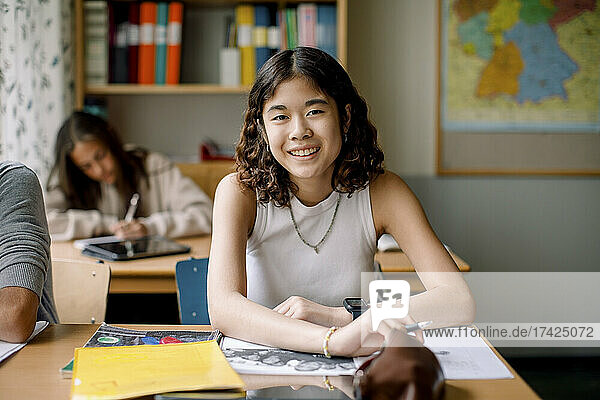Portrait of teenage girl in junior high classroom