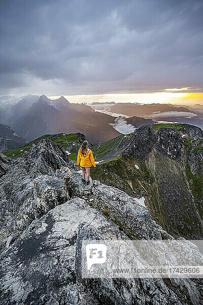 Sunset  hiker looking at mountains and peaks under dramatic clouds  Wetterstein Mountains  Garmisch-Partenkirchen  Bavaria  Germany  Europe