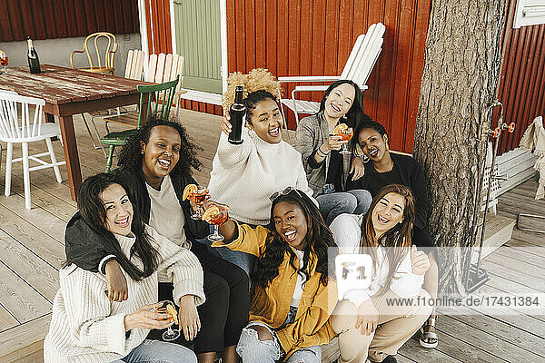 High angle portrait of female friends enjoying drink at party