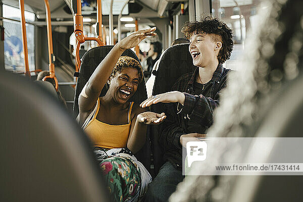Cheerful multiracial friends traveling in bus