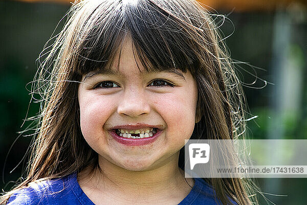 UK  Portrait of smiling girl (4-5) outdoors