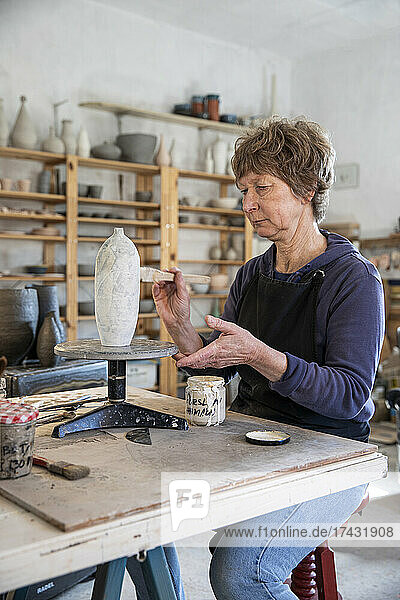 Spain  Baleares  Woman painting ceramics in workshop