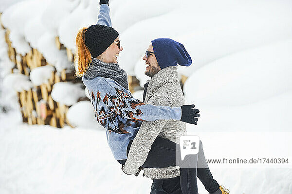 Happy couple enjoying during snow in winter