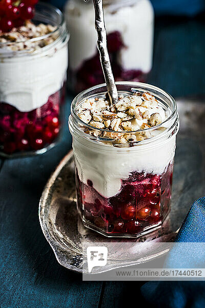 Yogurt parfait with red currant berries and nuts 