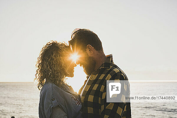 Bearded man romancing with girlfriend at beach